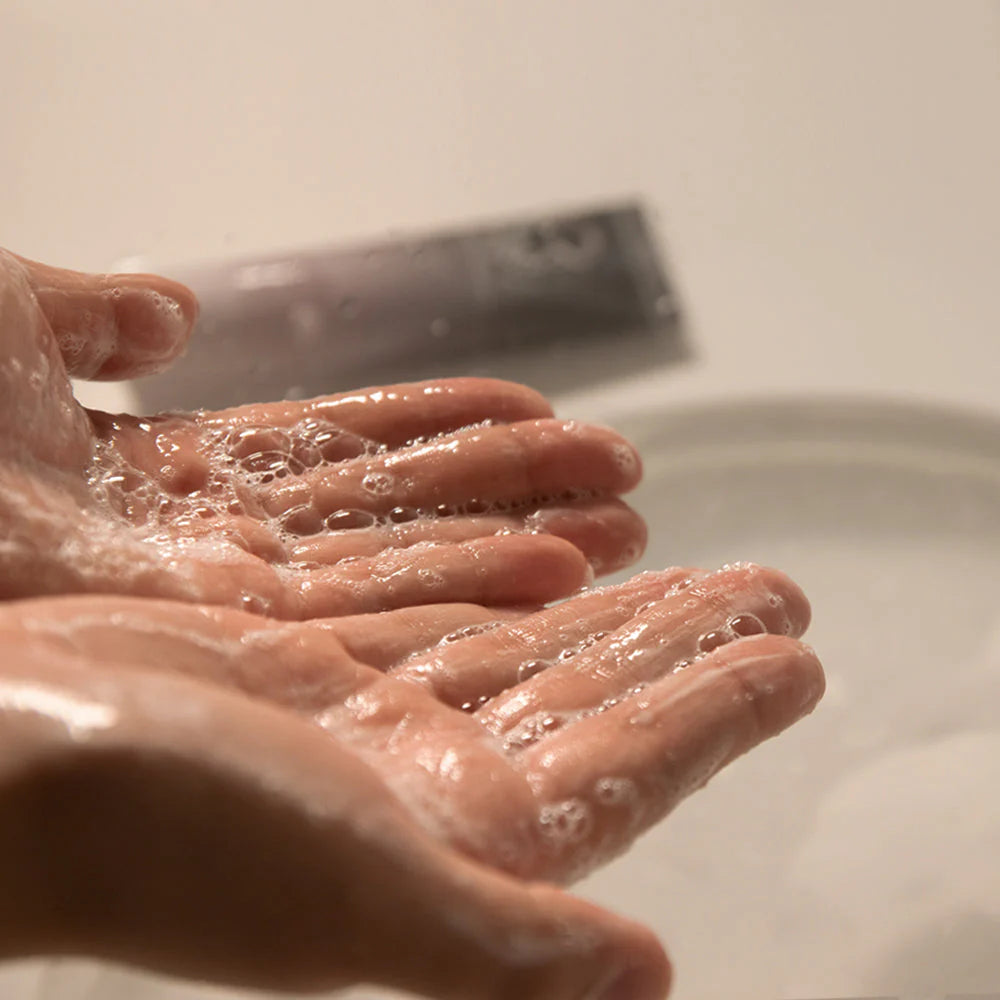 Foamy texture of Haruharu Wonder Black Rice Cleansing Gel lathered in hands during gentle face wash routine