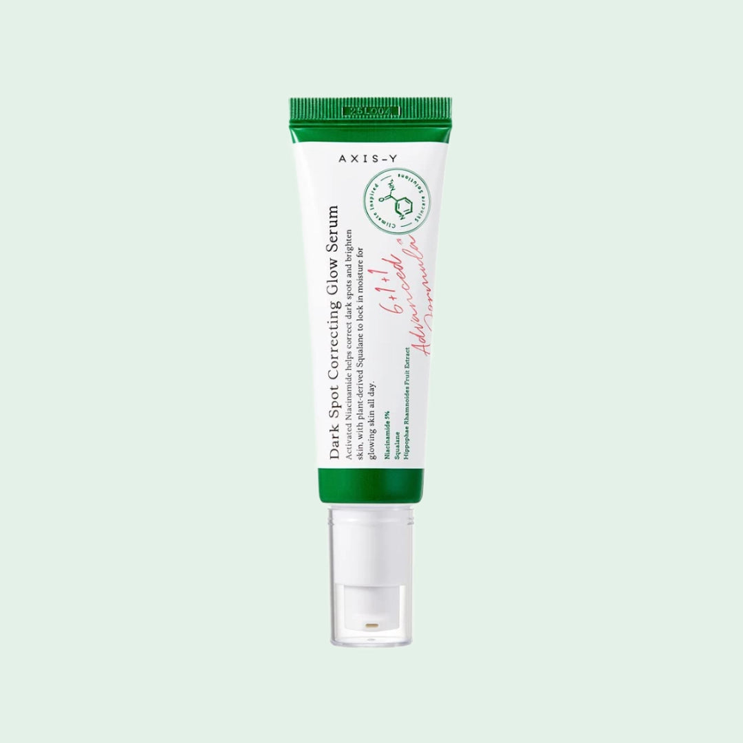 AXIS-Y Dark Spot Correcting Glow Serum in green and white tube, a brightening Korean skincare treatment with niacinamide for fading hyperpigmentation and evening out skin tone.
