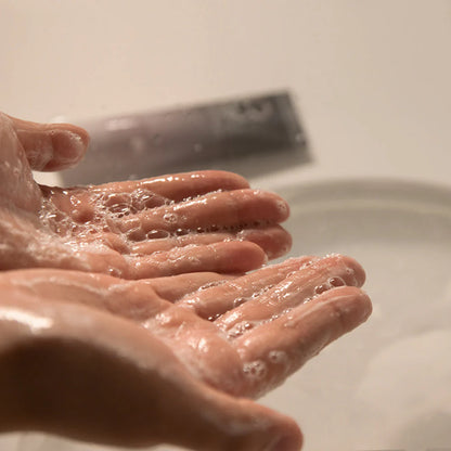 Foamy texture of Haruharu Wonder Black Rice Cleansing Gel lathered in hands during gentle face wash routine