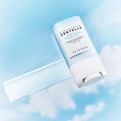 SKIN1004 Hyalu-Cica Silky-Fit Sun Stick with smooth swipe texture on blue sky background