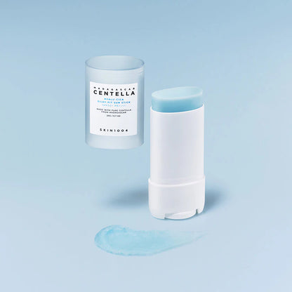 Open SKIN1004 Hyalu-Cica Silky-Fit Sun Stick with texture swipe on light blue background