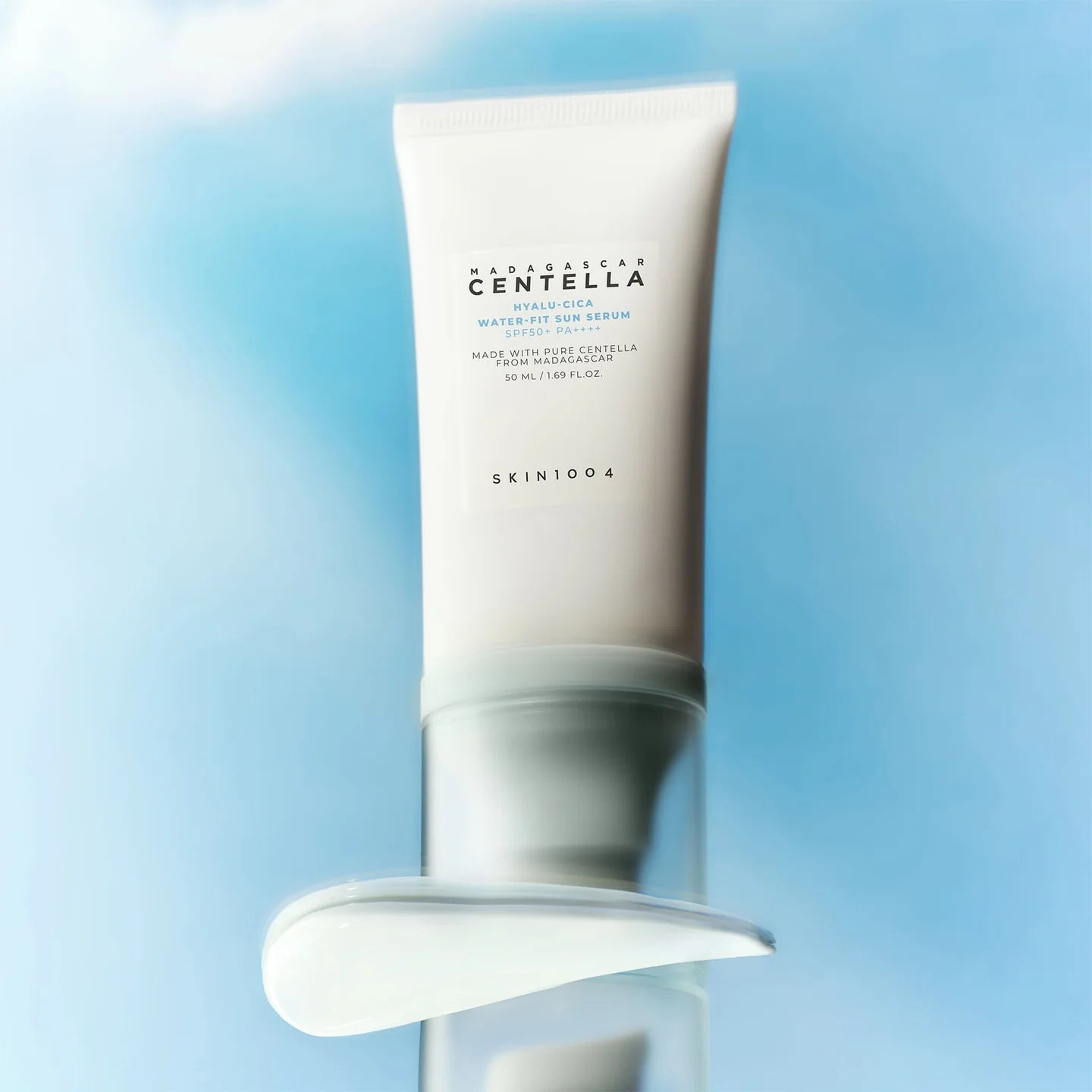SKIN1004 Hyalu-Cica Water-Fit Sun Serum with cream texture swipe on blue sky background