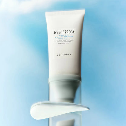 SKIN1004 Hyalu-Cica Water-Fit Sun Serum with cream texture swipe on blue sky background